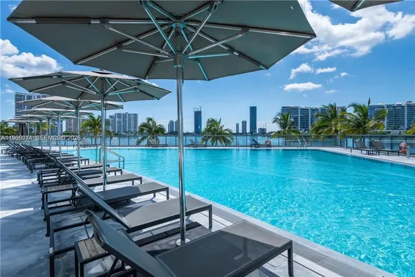 a view of a dining room with furniture and a large window
