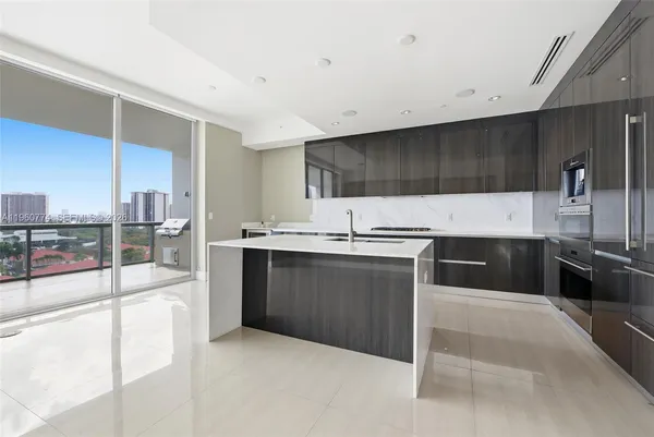 a large white kitchen with a large window