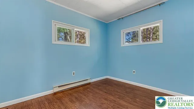 a view of a room with wooden floor and window