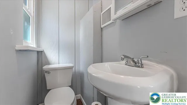 a white toilet sitting next to a white sink