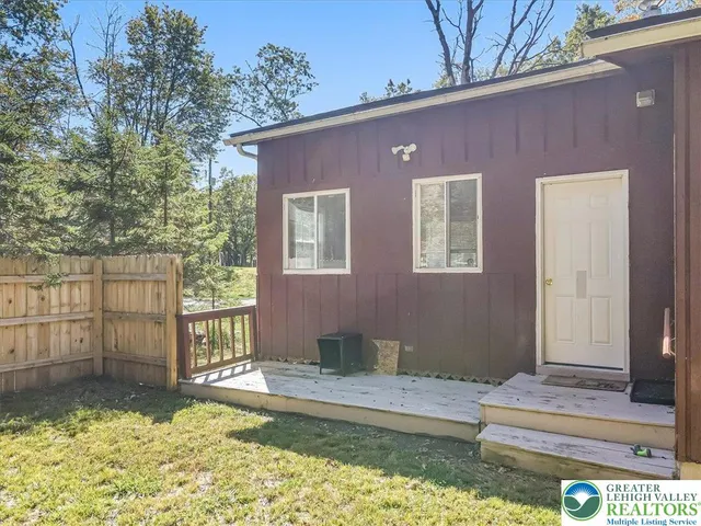 a view of a house with wooden floor and a small yard