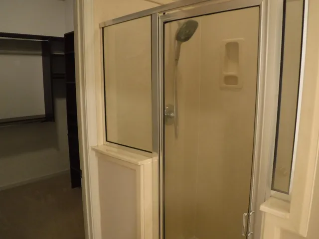 a bathroom with a glass shower door