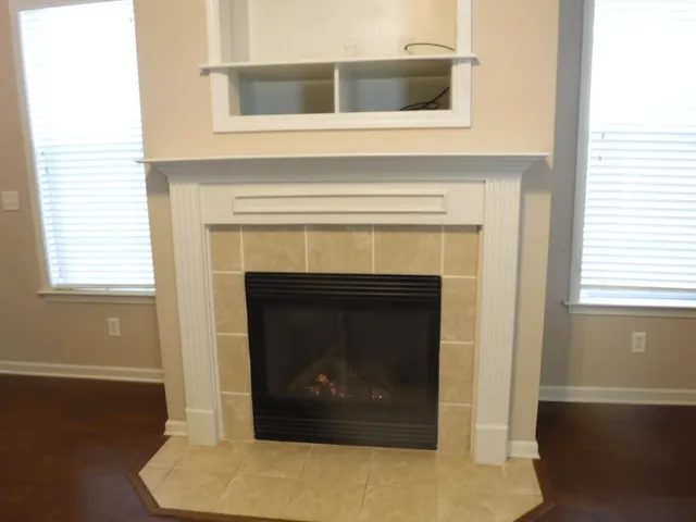 a living room with a fireplace and a wooden floor