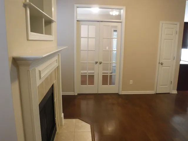 a view of a livingroom with wooden floor and a fireplace