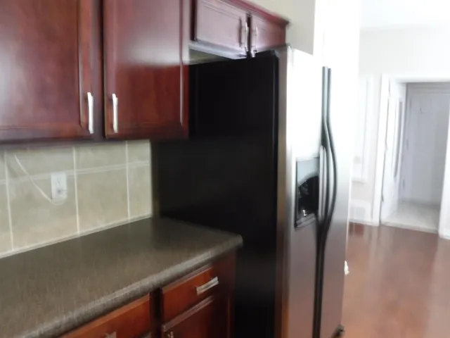 a kitchen with a refrigerator and a stove