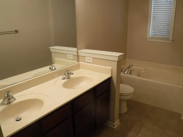 a bathroom with a sink toilet and tub