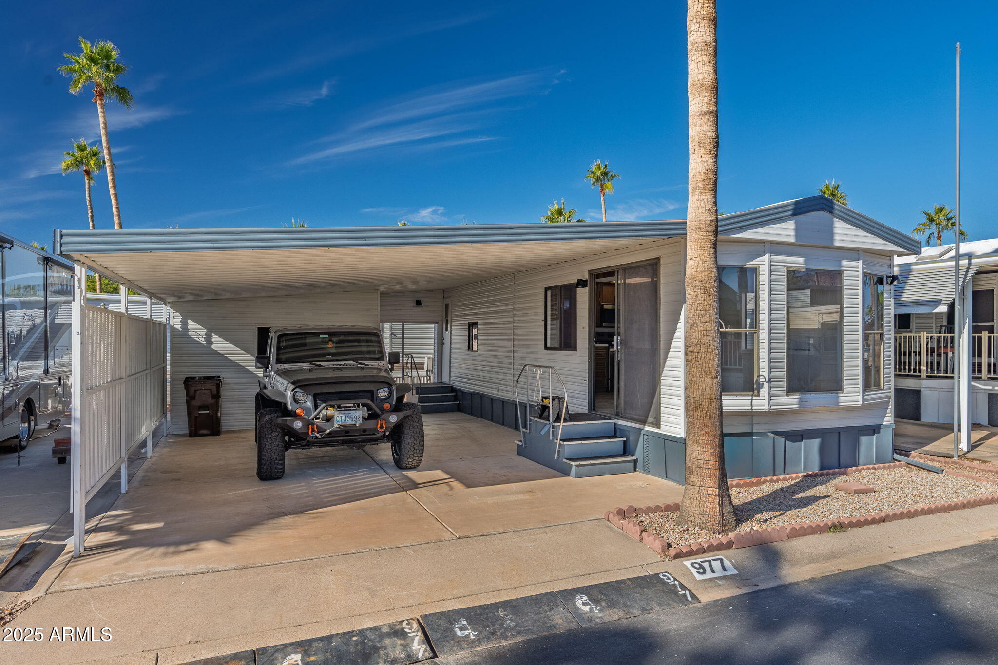 977 South Oxide Drive, Unit 977 Apache Junction, AZ 85119 - Photo 1 of 15 a view of a patio with table and chairs