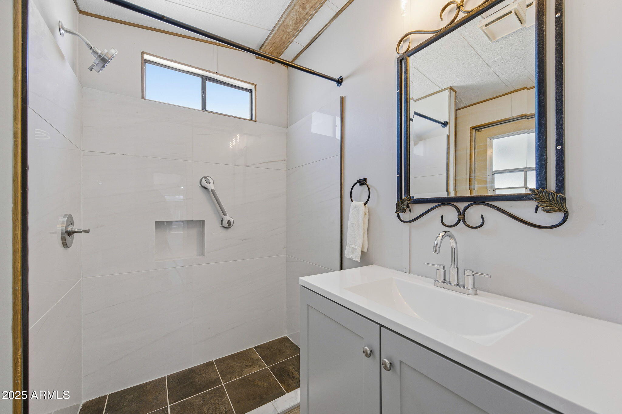 977 South Oxide Drive, Unit 977 Apache Junction, AZ 85119 - Photo 11 of 15 a bathroom with a sink and mirror
