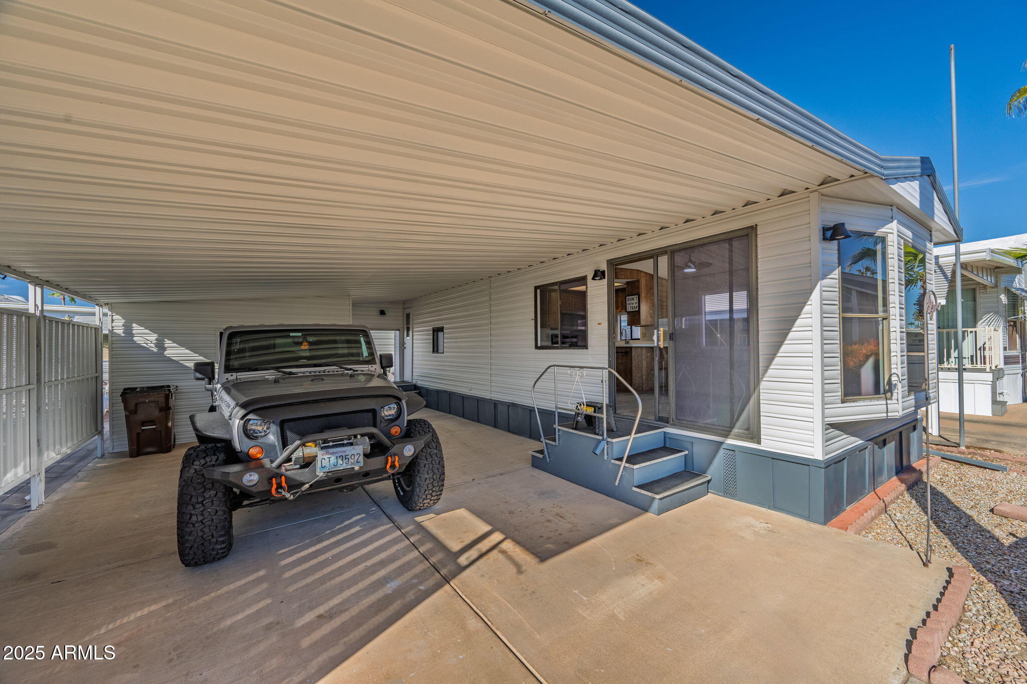 977 South Oxide Drive, Unit 977 Apache Junction, AZ 85119 - Photo 3 of 15 a view of a patio with wooden floor and furniture