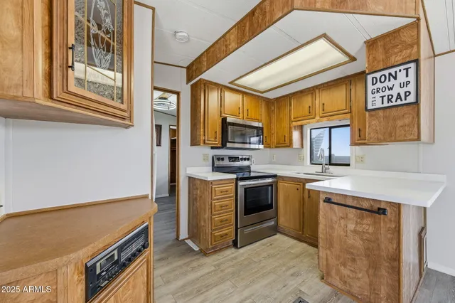 a kitchen with stainless steel appliances granite countertop a stove and a sink