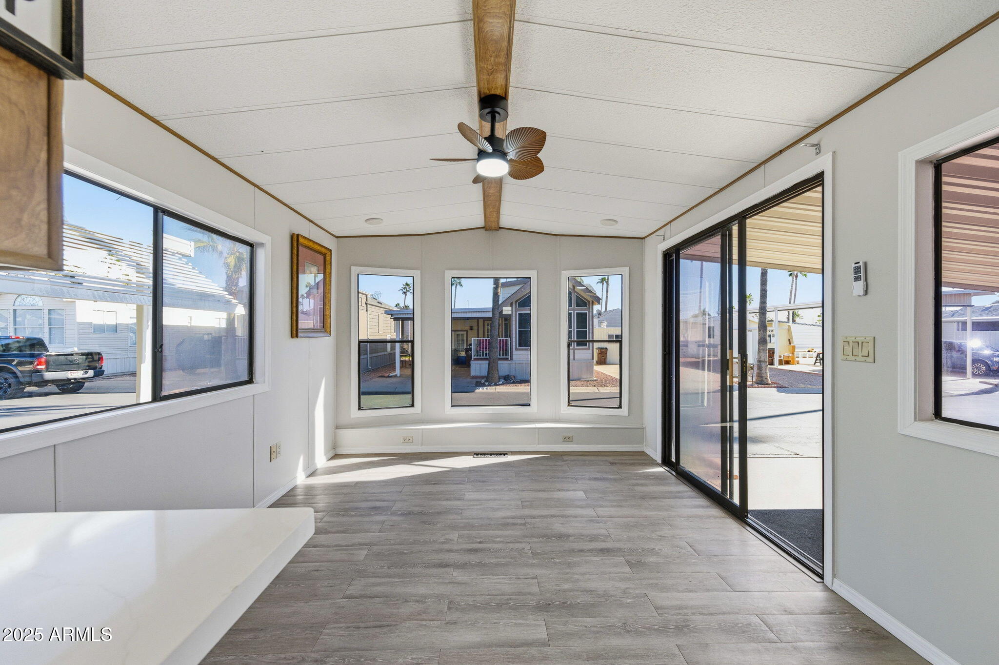 977 South Oxide Drive, Unit 977 Apache Junction, AZ 85119 - Photo 7 of 15 a view of an entryway with wooden floor and a chandelier fan