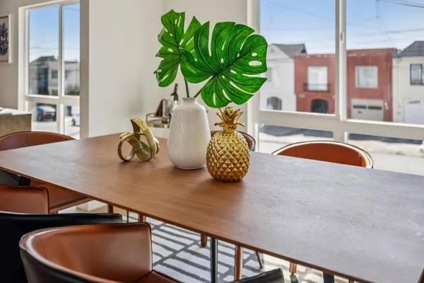 a kitchen with stainless steel appliances a sink a microwave a refrigerator and cabinets