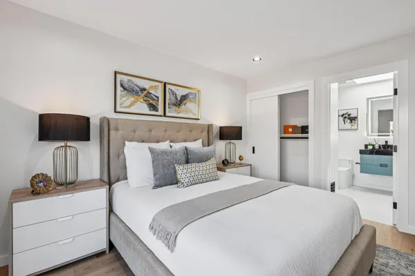 a bedroom with furniture and a large window