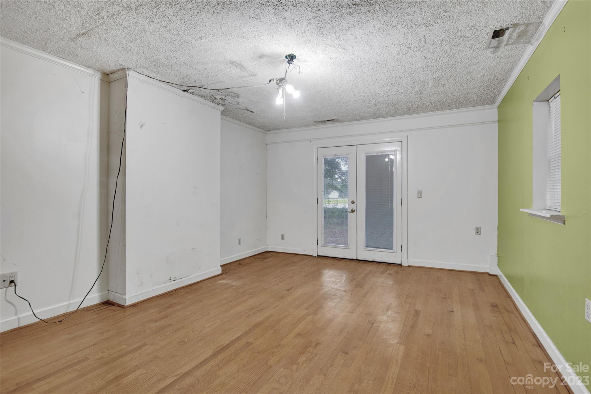 895 Perth Road Troutman, NC 28166 - Photo 13 of 18 a view of an empty room with wooden floor and a window