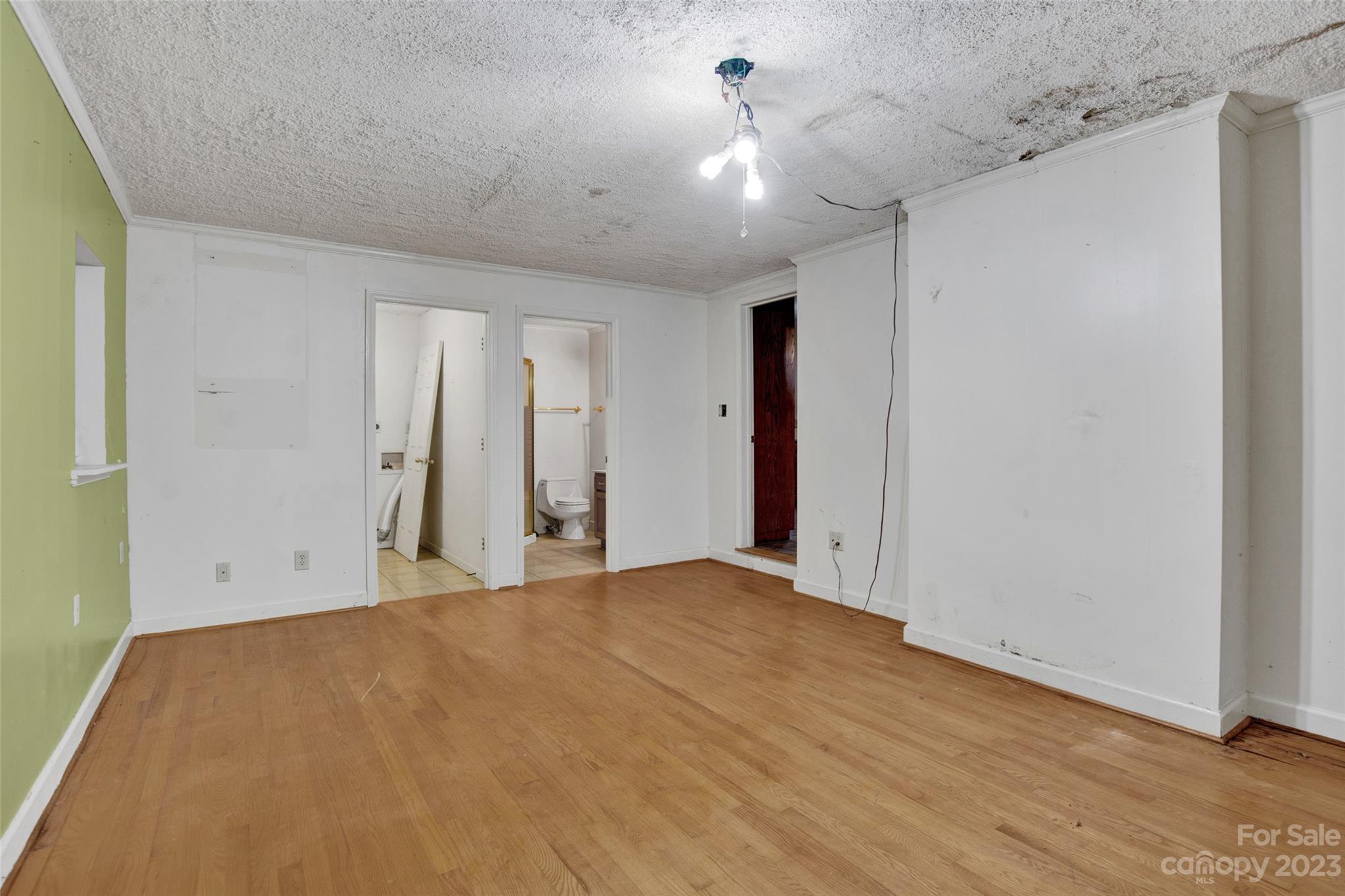 895 Perth Road Troutman, NC 28166 - Photo 14 of 18 a view of an empty room with wooden floor