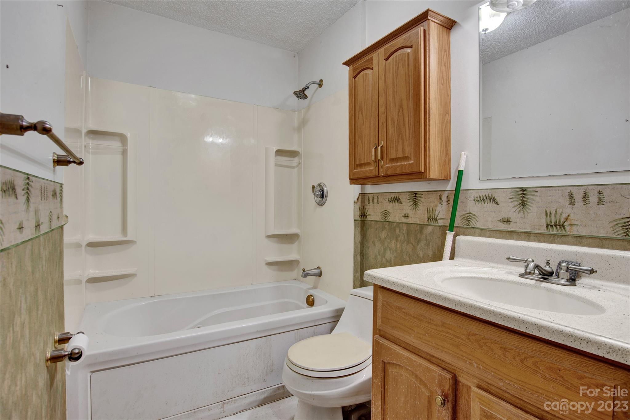 895 Perth Road Troutman, NC 28166 - Photo 8 of 18 a bathroom with a granite countertop sink a toilet and shower
