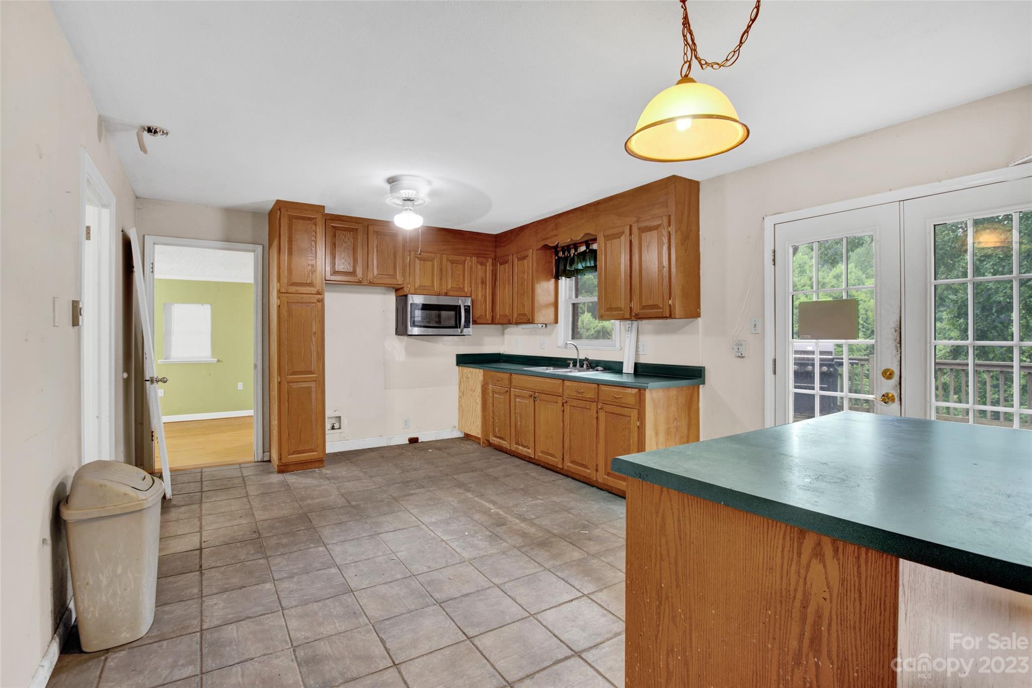 895 Perth Road Troutman, NC 28166 - Photo 10 of 18 a kitchen with stainless steel appliances granite countertop a sink refrigerator stove and microwave