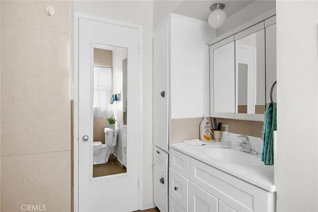 a en suite bathroom with a sink a toilet and a mirror