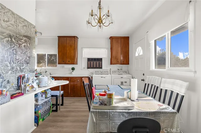 a view of a dining room with furniture and chandelier