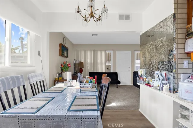 a view of a dining room with furniture and a chandelier