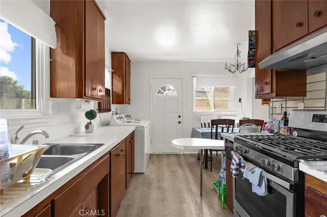 a kitchen with a sink stove and cabinets
