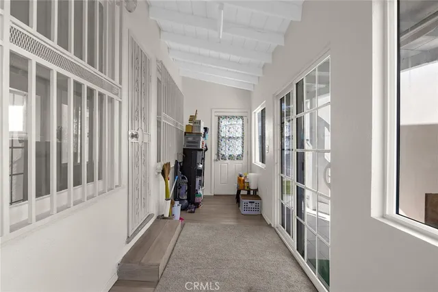 a view of hallway with closet and a window