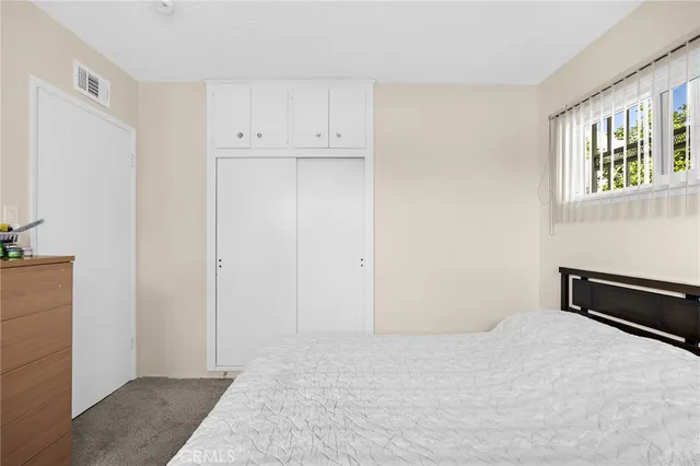 a bedroom with a bed and a window