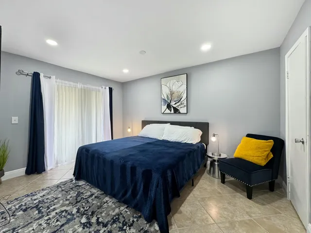 a bedroom with a bed and a painting on wall