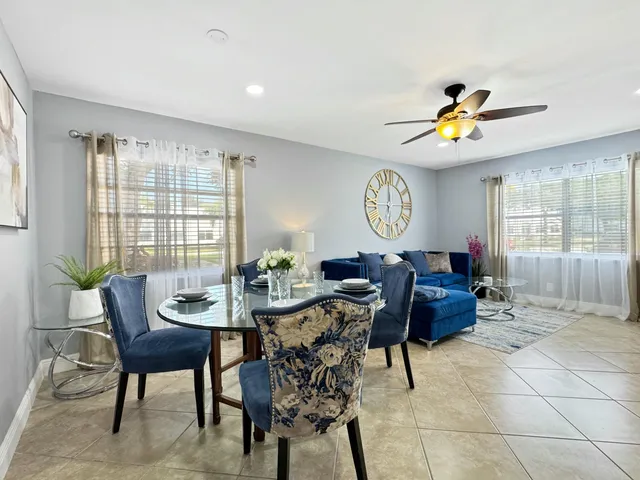 a view of a dining room and livingroom furniture a rug a chandelier and a wooden floor