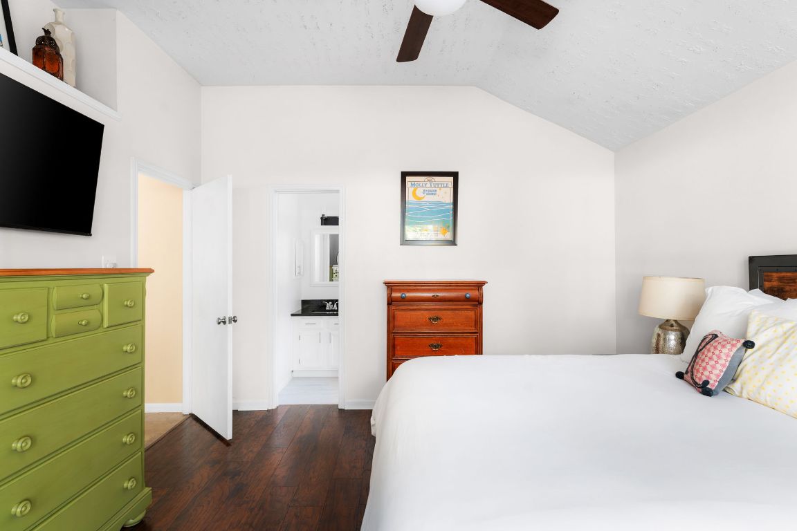 1412 Pigeon Forge Road Pflugerville, TX 78660 - Photo 11 of 20 a bedroom with a bed and flat screen tv