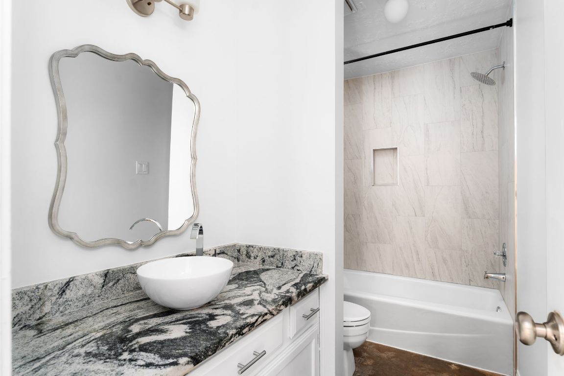 1412 Pigeon Forge Road Pflugerville, TX 78660 - Photo 15 of 20 a bathroom with a granite countertop sink toilet and shower