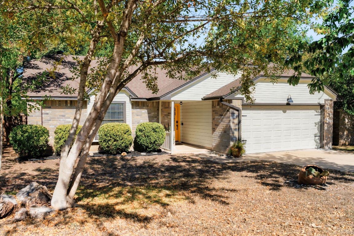 1412 Pigeon Forge Road Pflugerville, TX 78660 - Photo 19 of 20 a front view of a house with a yard and garage