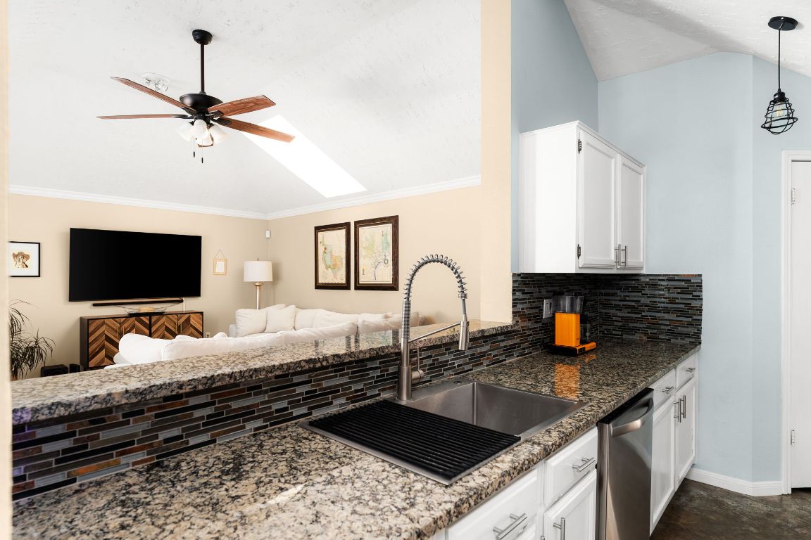 1412 Pigeon Forge Road Pflugerville, TX 78660 - Photo 20 of 20 a kitchen with a granite countertop sink and a stove top oven