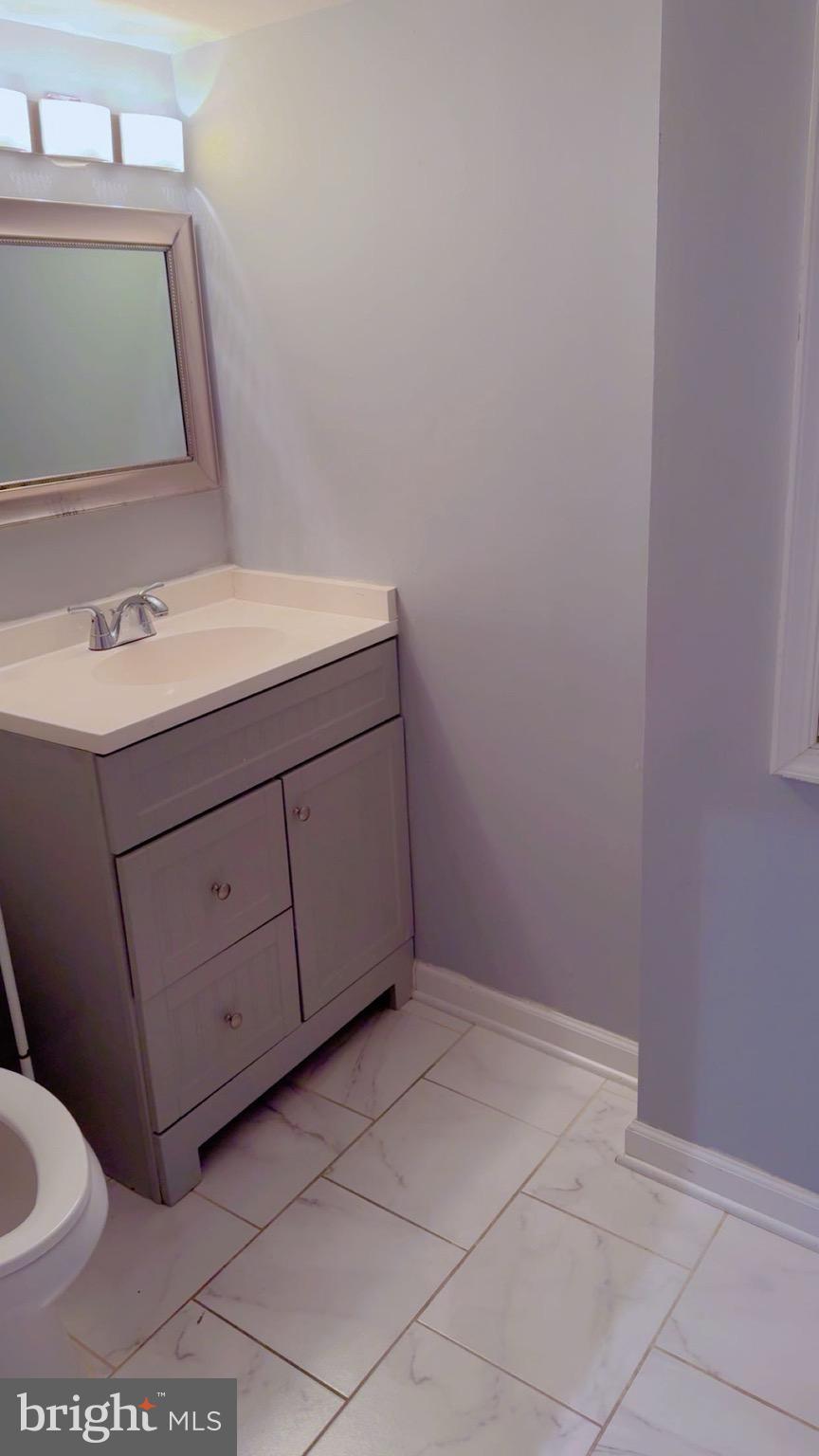 3300 Yellow Flower Road Laurel, MD 20724 - Photo 18 of 20 a bathroom with a sink vanity and toilet
