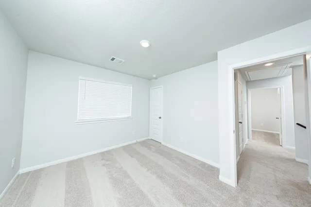 a view of a big room with windows and closet