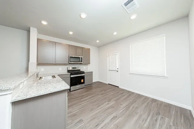 a kitchen with sink cabinets and microwave