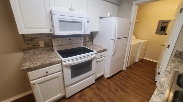 a view of a kitchen sink cabinets and wooden floor