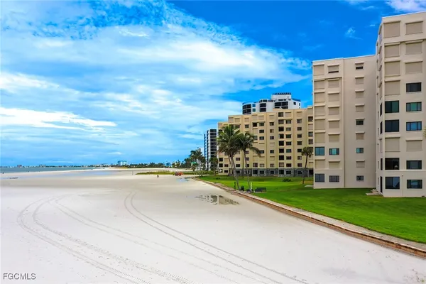 a kitchen with granite countertop a counter space chairs stainless steel appliances and cabinets