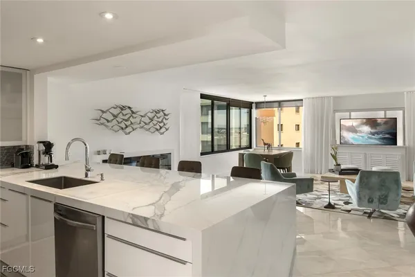 a living room with furniture a large window and a flat screen tv