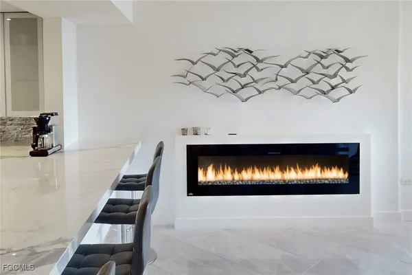 a living room with furniture a large window and a table