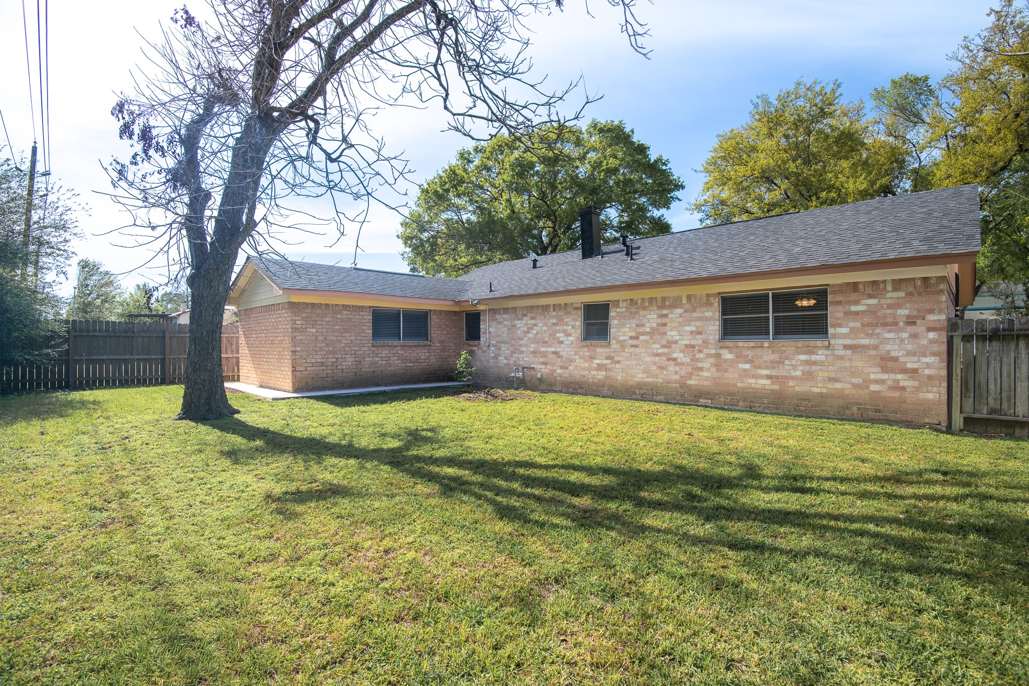 2510 Marble Falls Drive Spring, TX 77373 - Photo 23 of 26 a backyard of a house with table and chairs plants and large tree