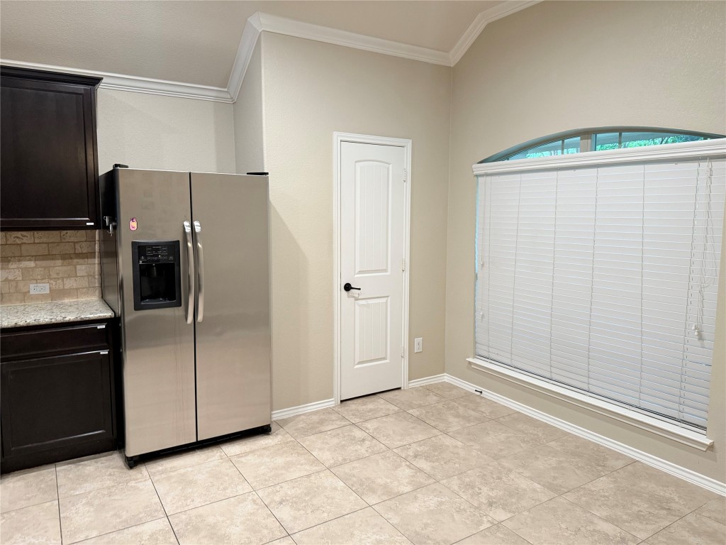 1704 Tranquility Lane Pflugerville, TX 78660 - Photo 14 of 19 a view of a kitchen with a refrigerator cabinet and a sink
