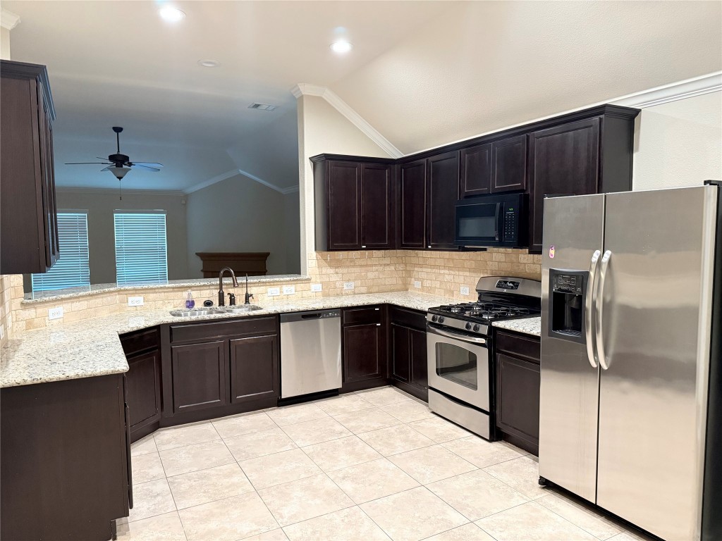 1704 Tranquility Lane Pflugerville, TX 78660 - Photo 15 of 19 a kitchen with a sink stove and refrigerator