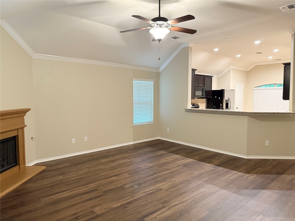 1704 Tranquility Lane Pflugerville, TX 78660 - Photo 9 of 19 an empty room with wooden floor and windows