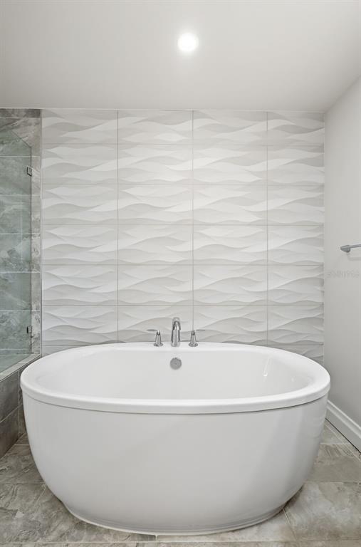 800 Collany Road, Unit 302 St. Petersburg, FL 33715 - Photo 60 of 66 a white bath tub sitting in a bathroom
