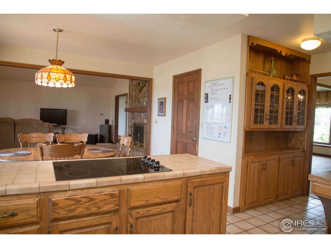 9354 Gunbarrel Ridge Road Boulder, CO 80301 - Photo 9 of 23 a living room with stainless steel appliances kitchen island granite countertop furniture and a flat screen tv