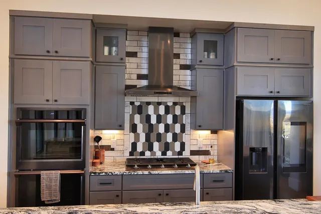 a kitchen with cabinets and stainless steel appliances