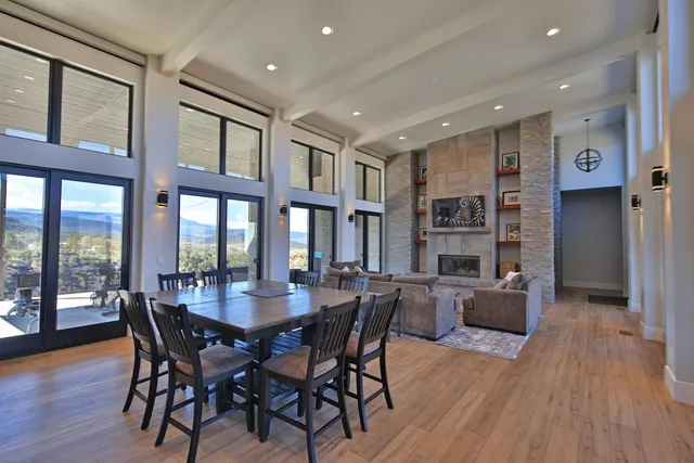a dining room with furniture window and wooden floor