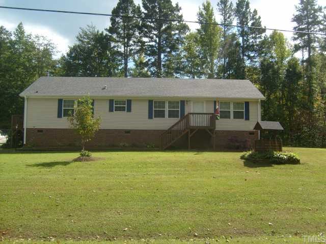 929 Holeman Ashley Road Timberlake, NC 27583 - Photo 1 of 6 a house that has a tree in front of it