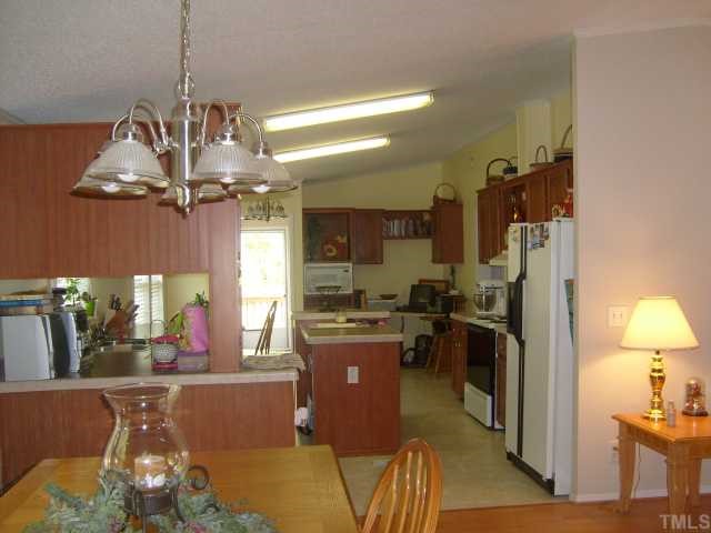 929 Holeman Ashley Road Timberlake, NC 27583 - Photo 4 of 6 a kitchen with refrigerator and cabinets